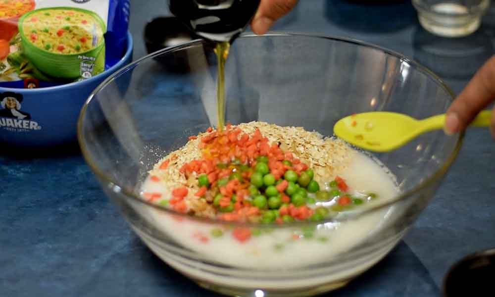 Adding-oil-in-Tangy-Oats-Breakfast-Muffins-batter adding oil in tangy oats breakfast muffins batter